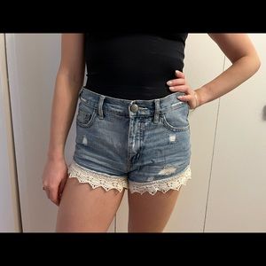 Free people denim shorts with lace trim